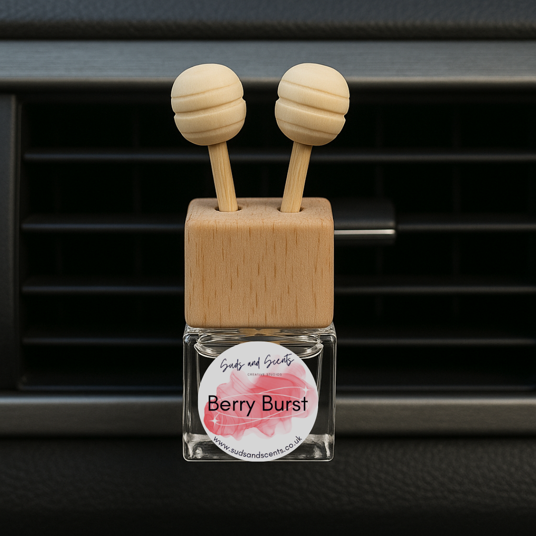 Car air freshener with wooden diffusers and 'Berry Burst' label in front of car vent.
